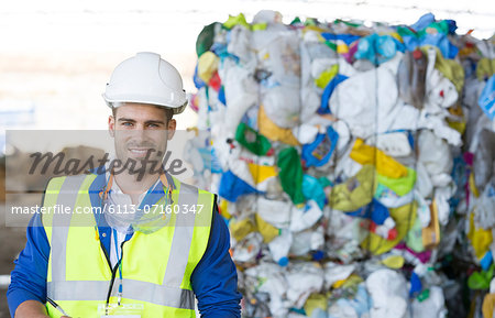 Worker smiling in recycling center