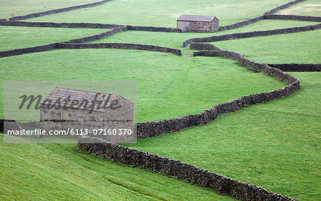 Stone houses and walls in green fields