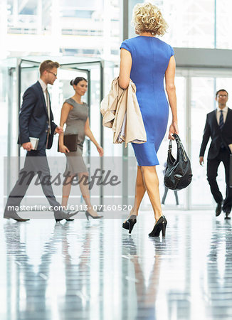 Business people walking in office lobby