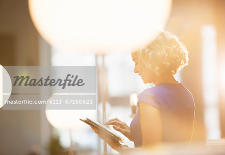 Businesswoman using digital tablet in office Businesswoman using digital tablet in office
