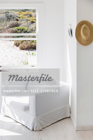Armchair next to window overlooking beach