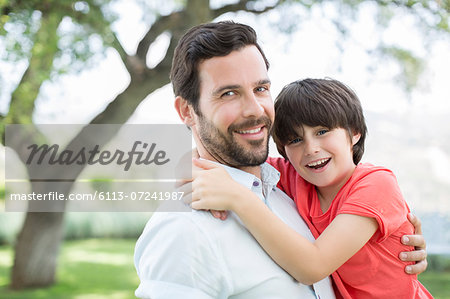 Father and son smiling outdoors