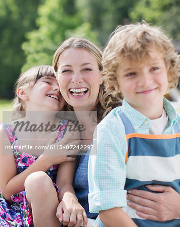 Mother and children smiling outdoors