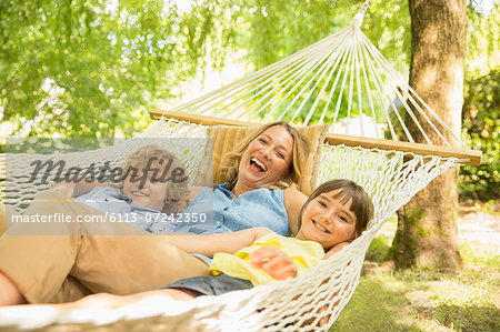 Mother and children relaxing in hammock Mother and children relaxing in hammock