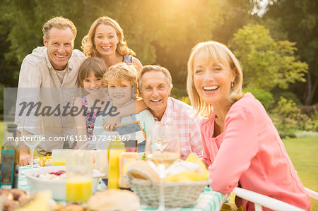 Multi-generation family at table in backyard