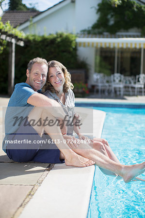 Couple relaxing at poolside