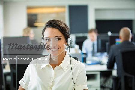 Businesswoman wearing headset in office