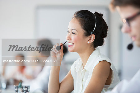 Businesswoman wearing headset in office