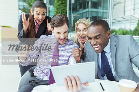 Business people cheering outdoors