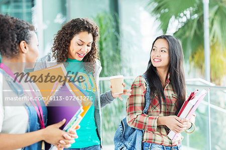 University students walking with books and coffee