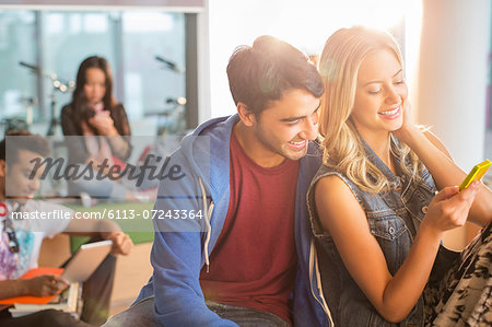 University students using cell phone in lounge