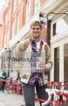 Man drinking coffee on city street