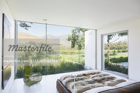 Modern bedroom overlooking rural landscape