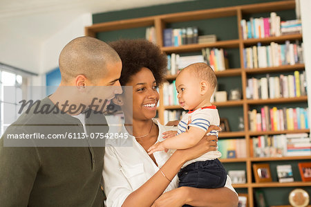 Couple holding baby in living room