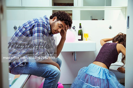 Drunk couple in bathroom at party