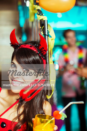 Woman wearing devil costume at party
