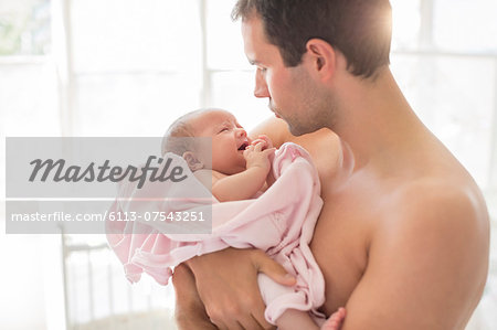 Father holding crying baby girl