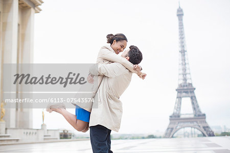 Couple hugging near Eiffel Tower, Paris, France