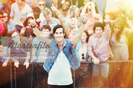 Portrait of performer with fans in background at music festival