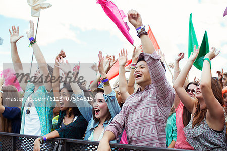 Fans cheering at music festival