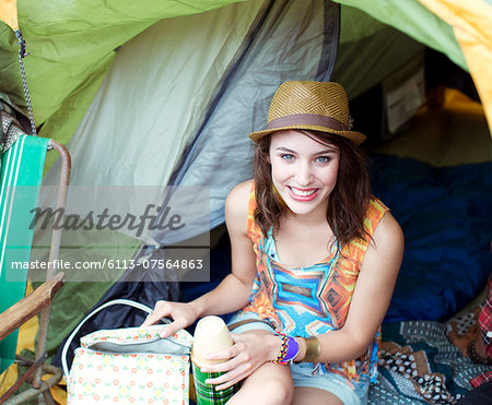 Portrait of smiling woman in tent at music festival