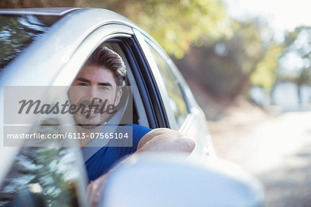 Portrait of happy man driving car