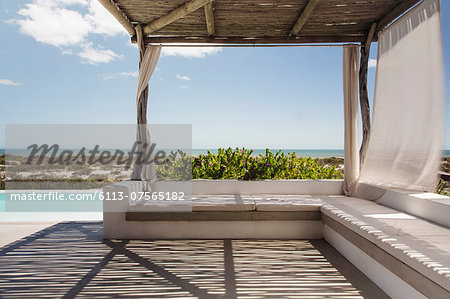 Luxury poolside patio overlooking ocean