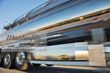 Blurred view of stainless steel milk tanker on the move