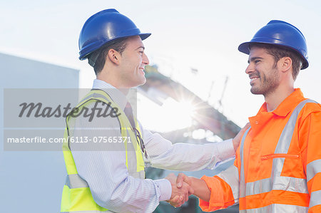 Businessman and worker handshaking