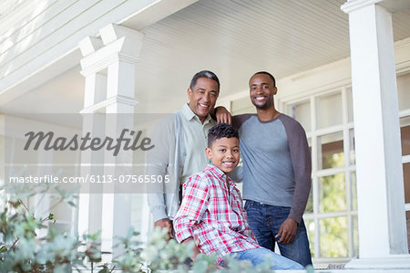 Portrait of smiling multi-generation men on porch