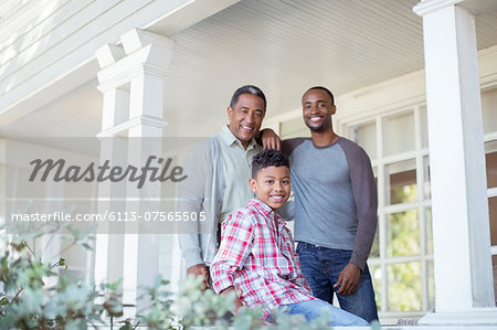 Portrait of smiling multi-generation men on porch Portrait of smiling multi-generation men on porch