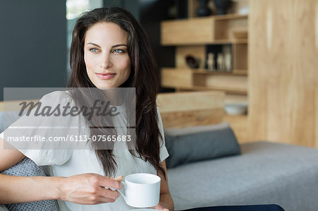 Woman drinking coffee in livingroom