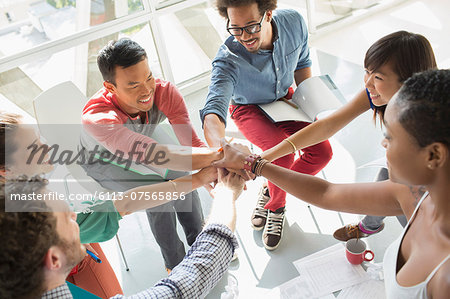 Creative business people connecting hands in huddle Creative business people connecting hands in huddle
