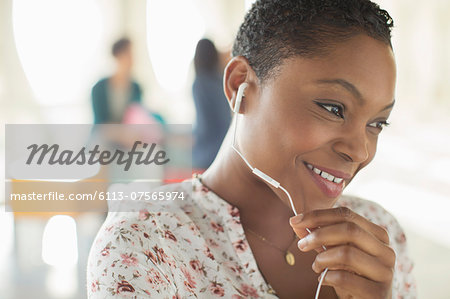 Close up of smiling woman using hands-free device