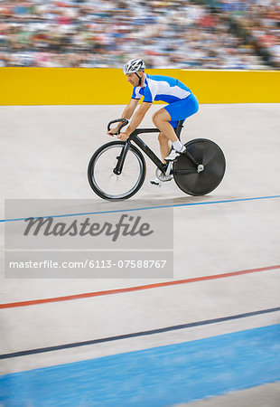 Track cyclist riding in velodrome