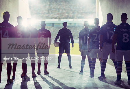 Silhouette of soccer teams facing field