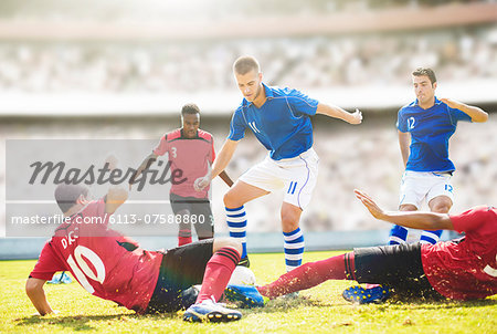 Soccer players sliding on field Soccer players sliding on field