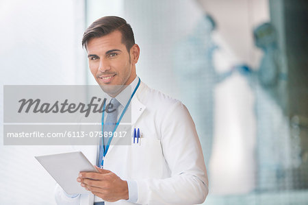 Portrait of confident doctor with digital tablet
