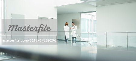 Doctors talking in hospital corridor Doctors talking in hospital corridor