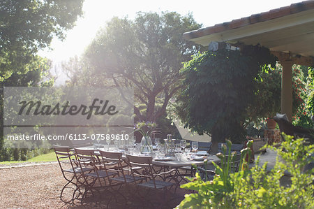 Place settings on sunny rural patio table