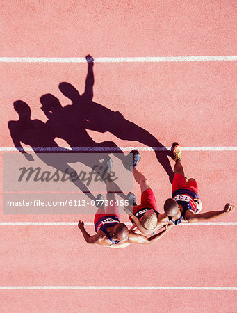 Runners walking with arms around each other on track