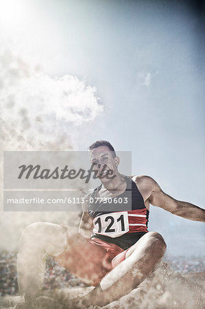 Long jumper landing in sand