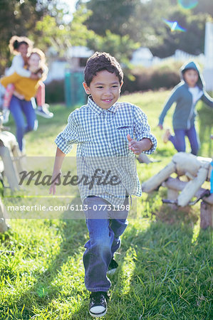 Boy walking in grass outdoors