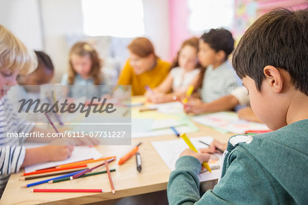 Teacher and students drawing in classroom