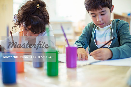 Students painting in classroom