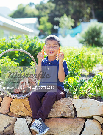 Boy with basket of produce in garden