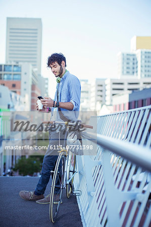 Man using cell phone on city street
