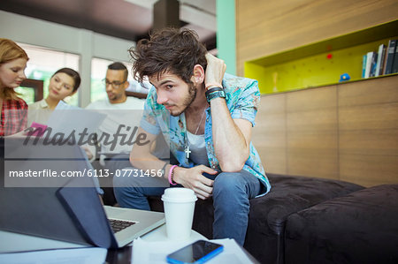 People working at laptop in office