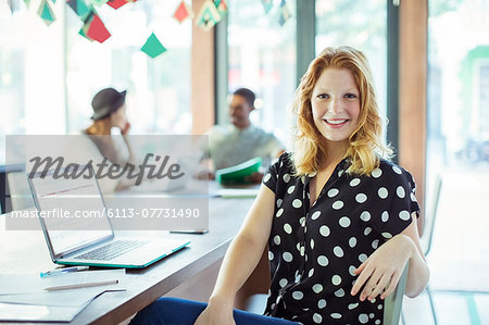 People working at conference table in office