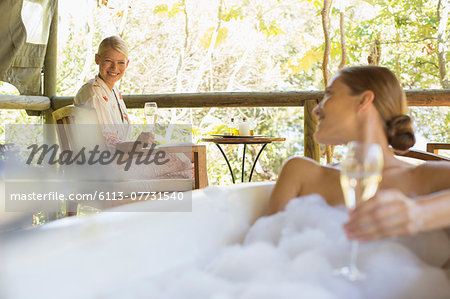 Women drinking wine together in spa